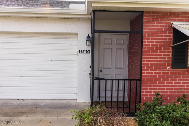 doorway to property with a garage