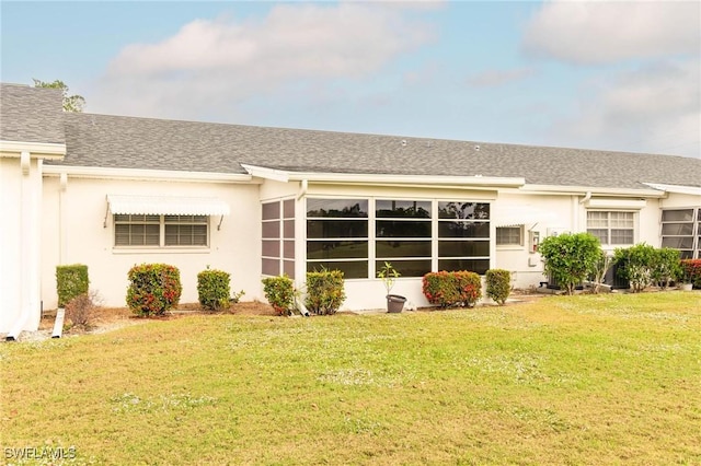 rear view of house with a yard