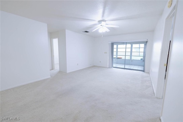 carpeted empty room featuring ceiling fan