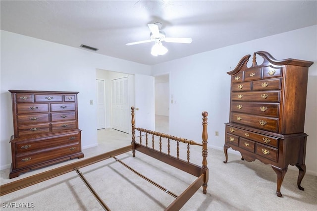 bedroom featuring ceiling fan, light colored carpet, and a closet