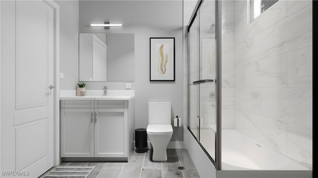 bathroom featuring a shower with door, vanity, and toilet