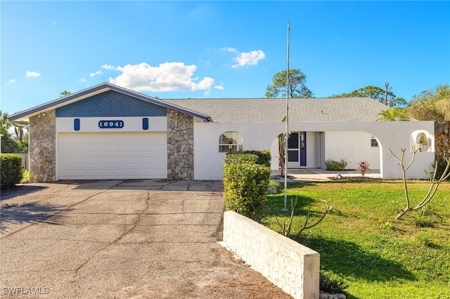 ranch-style home with a front yard and a garage