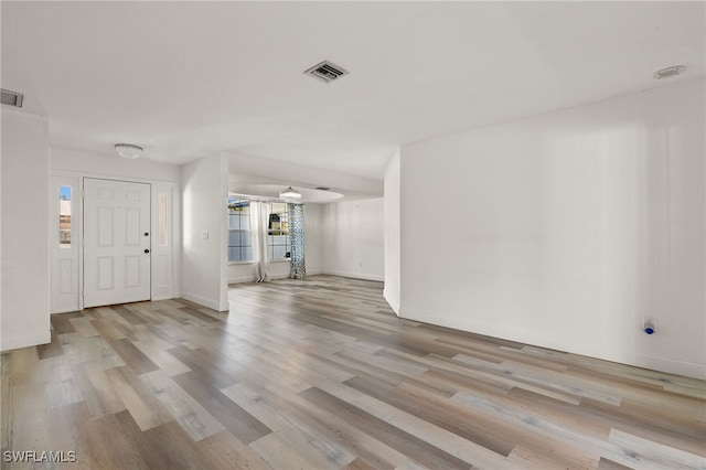 foyer entrance with ceiling fan and light hardwood / wood-style floors