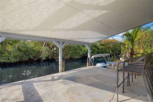 view of patio / terrace featuring a dock and a water view