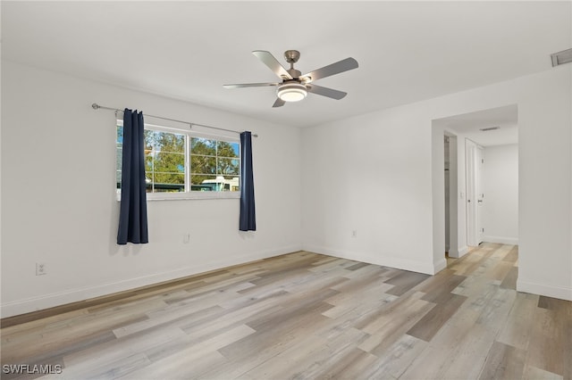 spare room with light hardwood / wood-style floors and ceiling fan