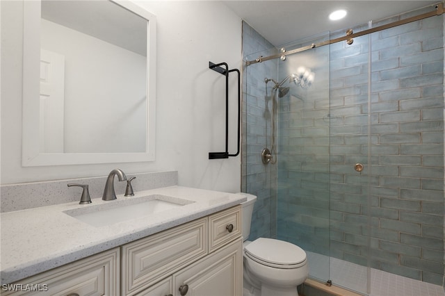 bathroom featuring vanity, toilet, and walk in shower