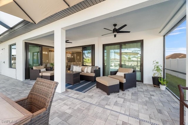 view of patio featuring an outdoor hangout area, ceiling fan, and fence