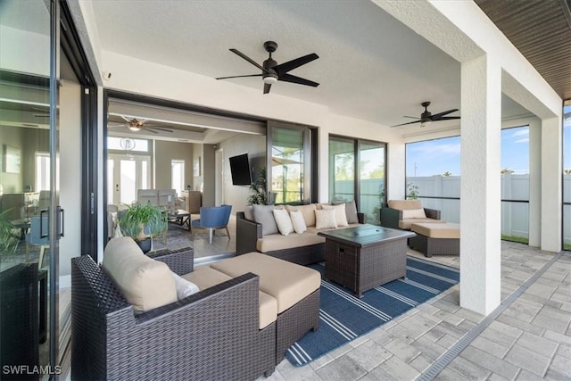 view of patio / terrace with ceiling fan, fence, and an outdoor hangout area