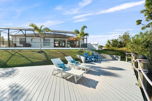 wooden deck featuring a lanai and a yard