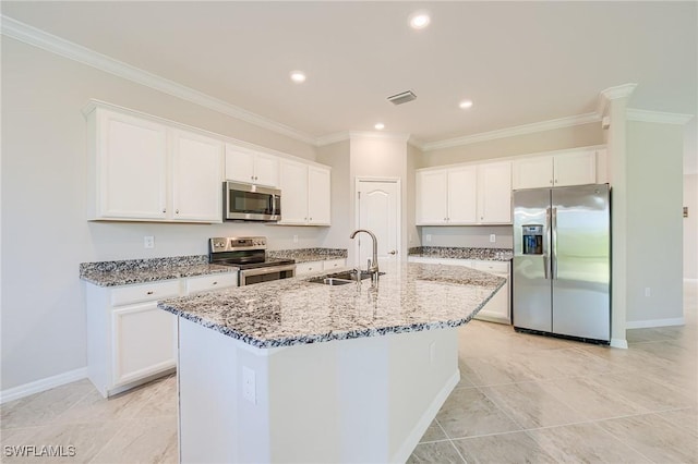 kitchen featuring light stone counters, stainless steel appliances, sink, a center island with sink, and white cabinets