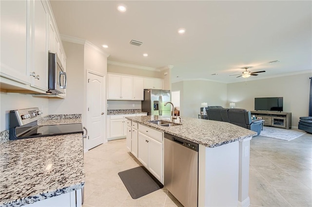 kitchen featuring stainless steel appliances, white cabinetry, a kitchen island with sink, and sink