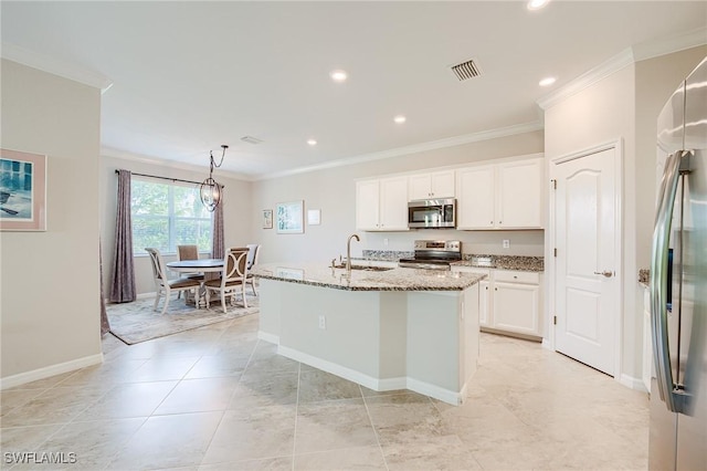 kitchen featuring white cabinetry, stone counters, sink, stainless steel appliances, and a kitchen island with sink