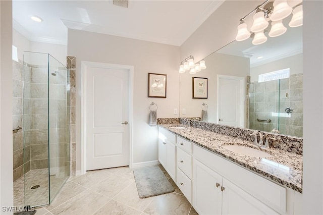 bathroom with tile patterned floors, vanity, ornamental molding, and tiled shower