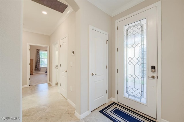 foyer entrance featuring light tile patterned floors and ornamental molding