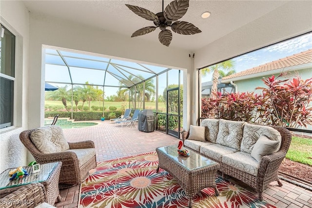 sunroom / solarium featuring ceiling fan