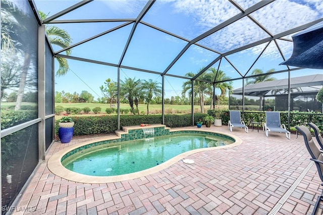 view of pool featuring pool water feature, glass enclosure, a patio area, and a hot tub