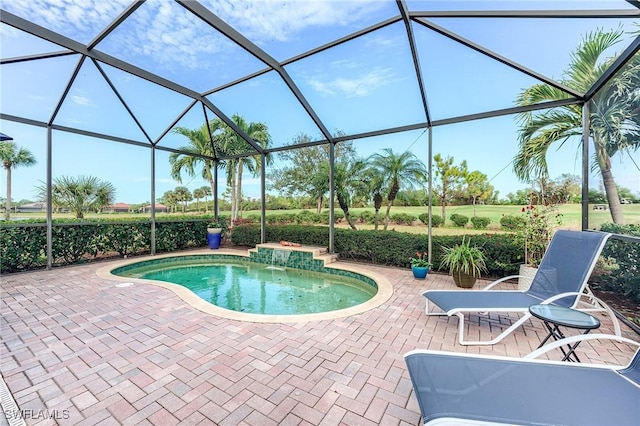 view of swimming pool featuring a lanai and a patio area