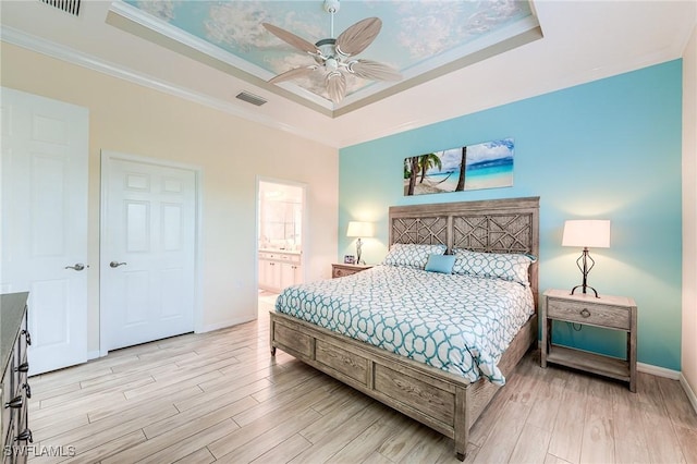 bedroom featuring ceiling fan, crown molding, and a raised ceiling