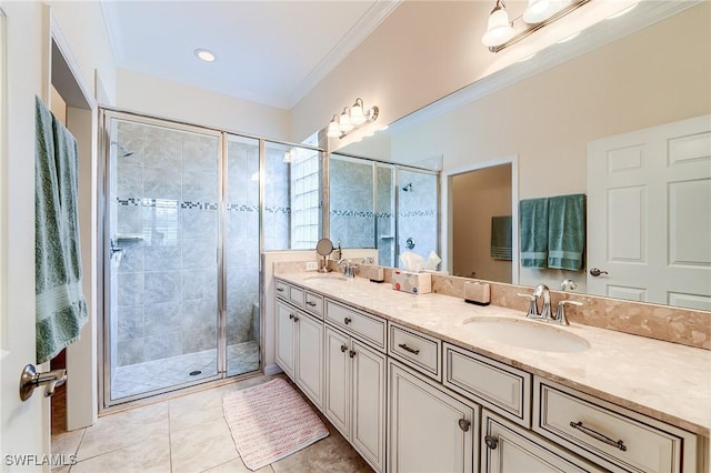 bathroom featuring ornamental molding, tile patterned flooring, a shower with shower door, and vanity