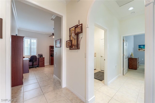 hall with light tile patterned floors and ornamental molding