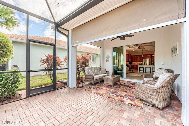 sunroom featuring ceiling fan