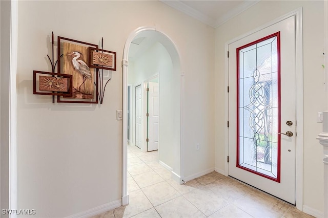 entrance foyer with light tile patterned floors and crown molding