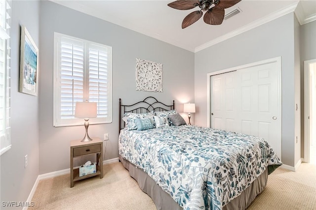 bedroom with ceiling fan, a closet, light carpet, and multiple windows