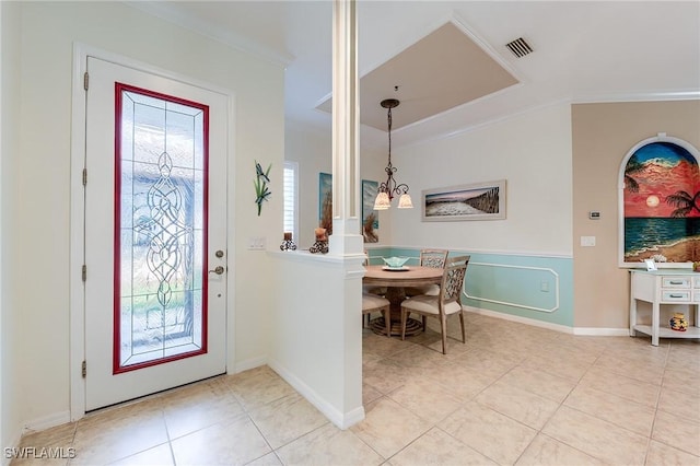 tiled foyer featuring ornamental molding