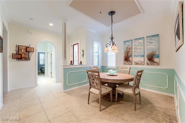 dining room with an inviting chandelier, light tile patterned floors, and ornamental molding