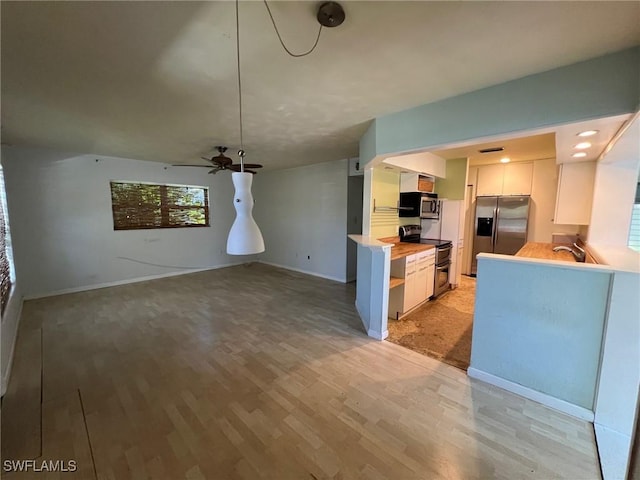 kitchen featuring white cabinets, black electric range oven, stainless steel fridge with ice dispenser, and light hardwood / wood-style floors