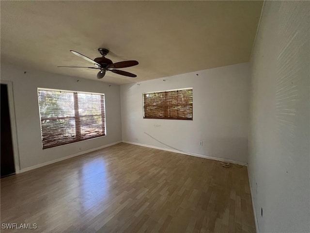 spare room with ceiling fan and wood-type flooring