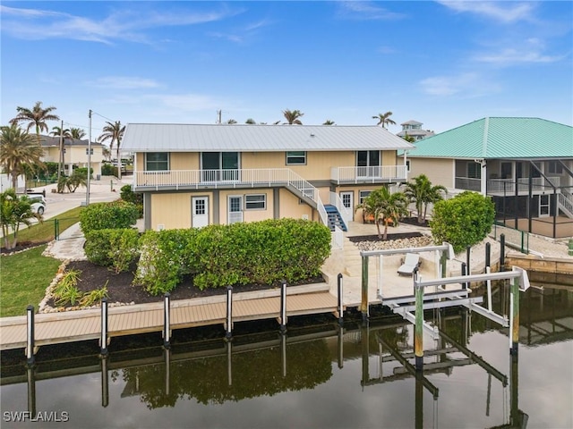 view of dock with a water view and a balcony