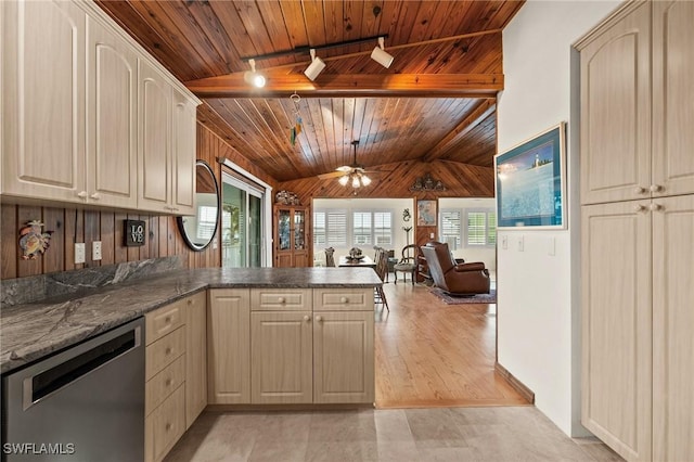 kitchen featuring kitchen peninsula, rail lighting, stainless steel dishwasher, ceiling fan, and dark stone countertops