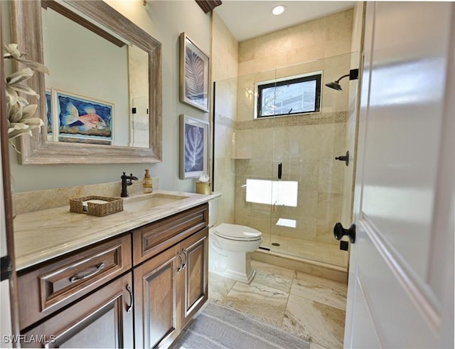 bathroom with vanity, toilet, and an enclosed shower