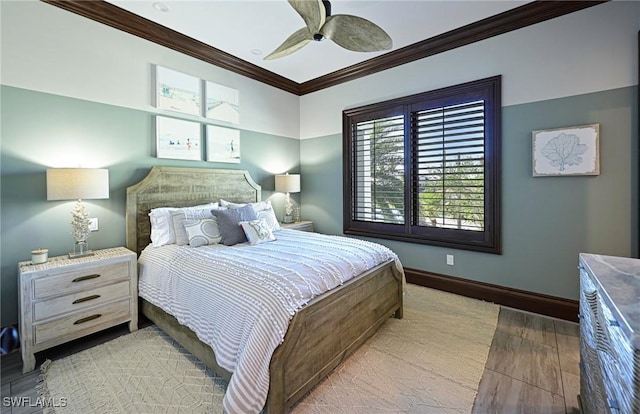 bedroom with light hardwood / wood-style floors, ceiling fan, and ornamental molding