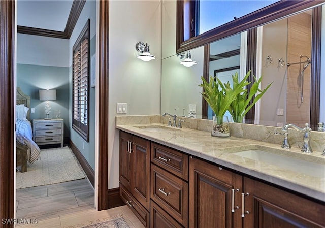 bathroom with crown molding and vanity