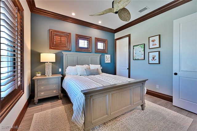 bedroom with light wood-type flooring, ceiling fan, and ornamental molding