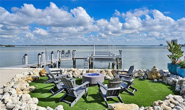 dock area featuring a water view and an outdoor fire pit