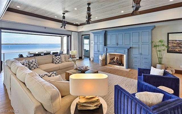 living room featuring light wood-type flooring, a water view, ornamental molding, and wood ceiling