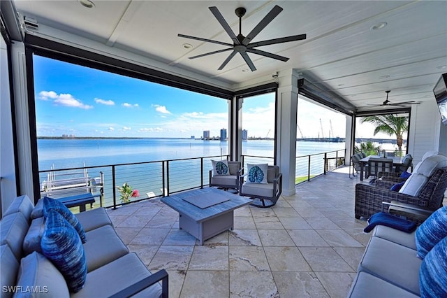 view of patio / terrace with an outdoor living space, a balcony, and a water view