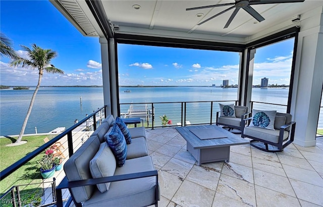 view of patio with an outdoor hangout area, a water view, and a balcony