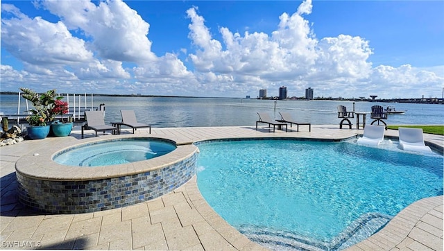 view of swimming pool featuring an in ground hot tub, a water view, and a patio