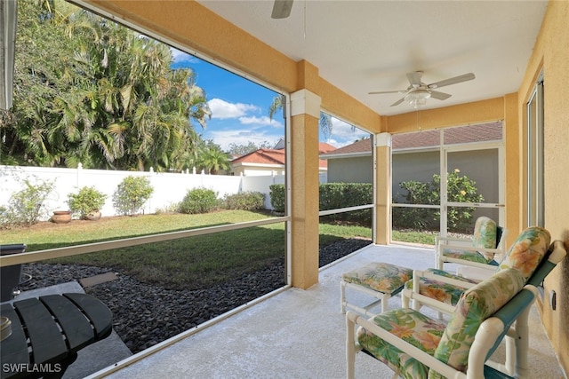 sunroom / solarium featuring ceiling fan