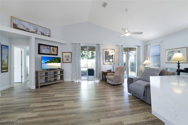 living room with ceiling fan, dark hardwood / wood-style flooring, and lofted ceiling