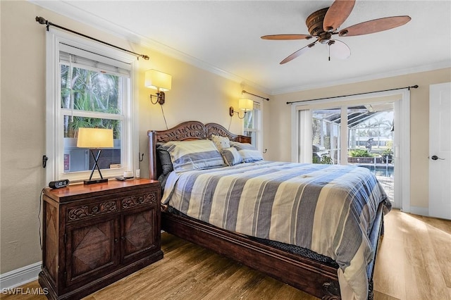 bedroom featuring ceiling fan, light hardwood / wood-style floors, access to exterior, and crown molding