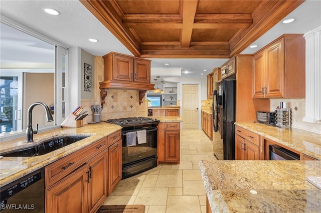 kitchen with light stone countertops, coffered ceiling, sink, black appliances, and beamed ceiling