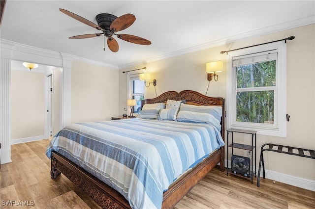 bedroom featuring ceiling fan, wood-type flooring, and ornamental molding