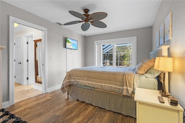 bedroom with ceiling fan and wood-type flooring