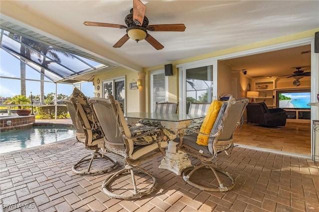 sunroom / solarium featuring a pool and ceiling fan