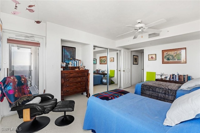 bedroom featuring light carpet, ceiling fan, a closet, and visible vents